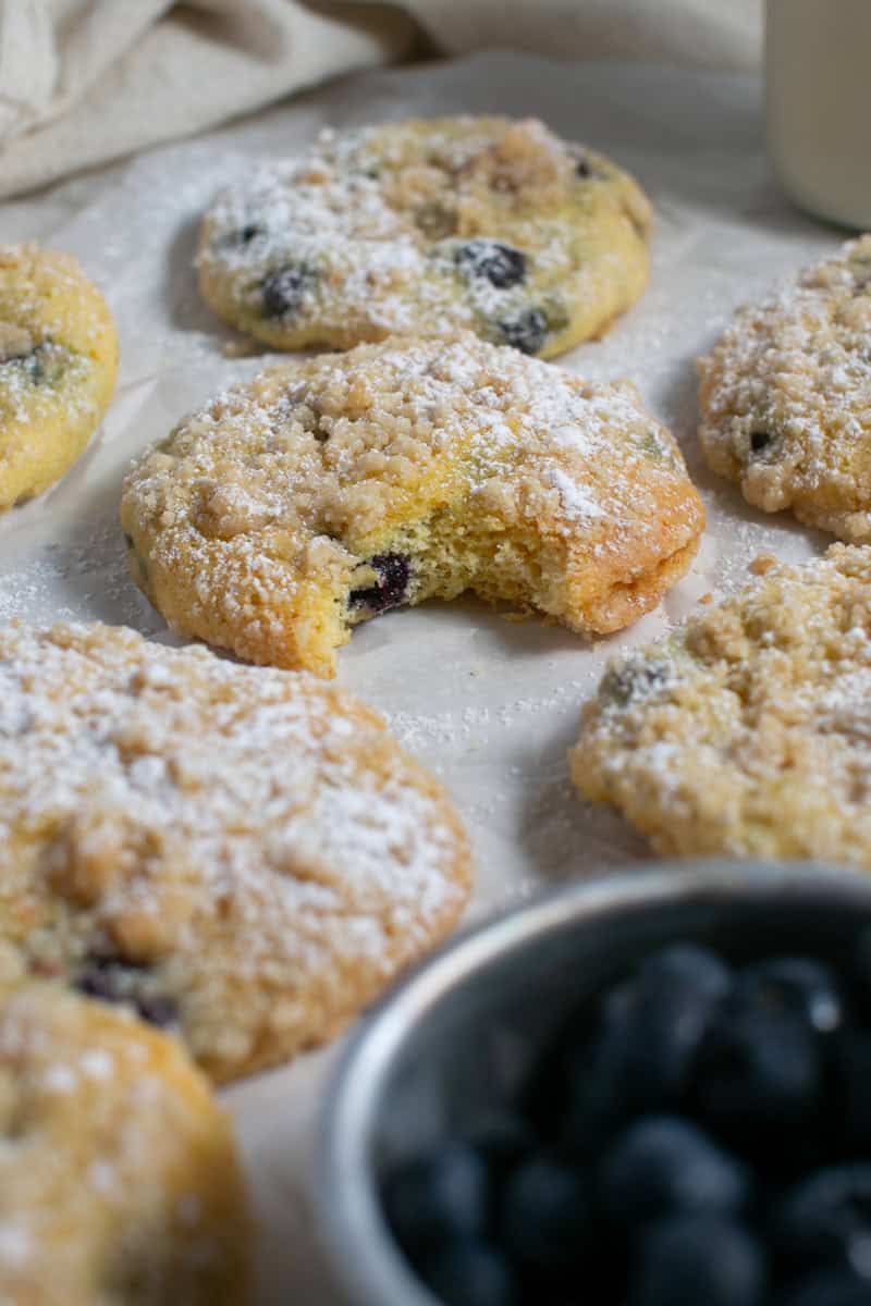 Cake mix blueberry muffin tops with a bowl of blueberries. 