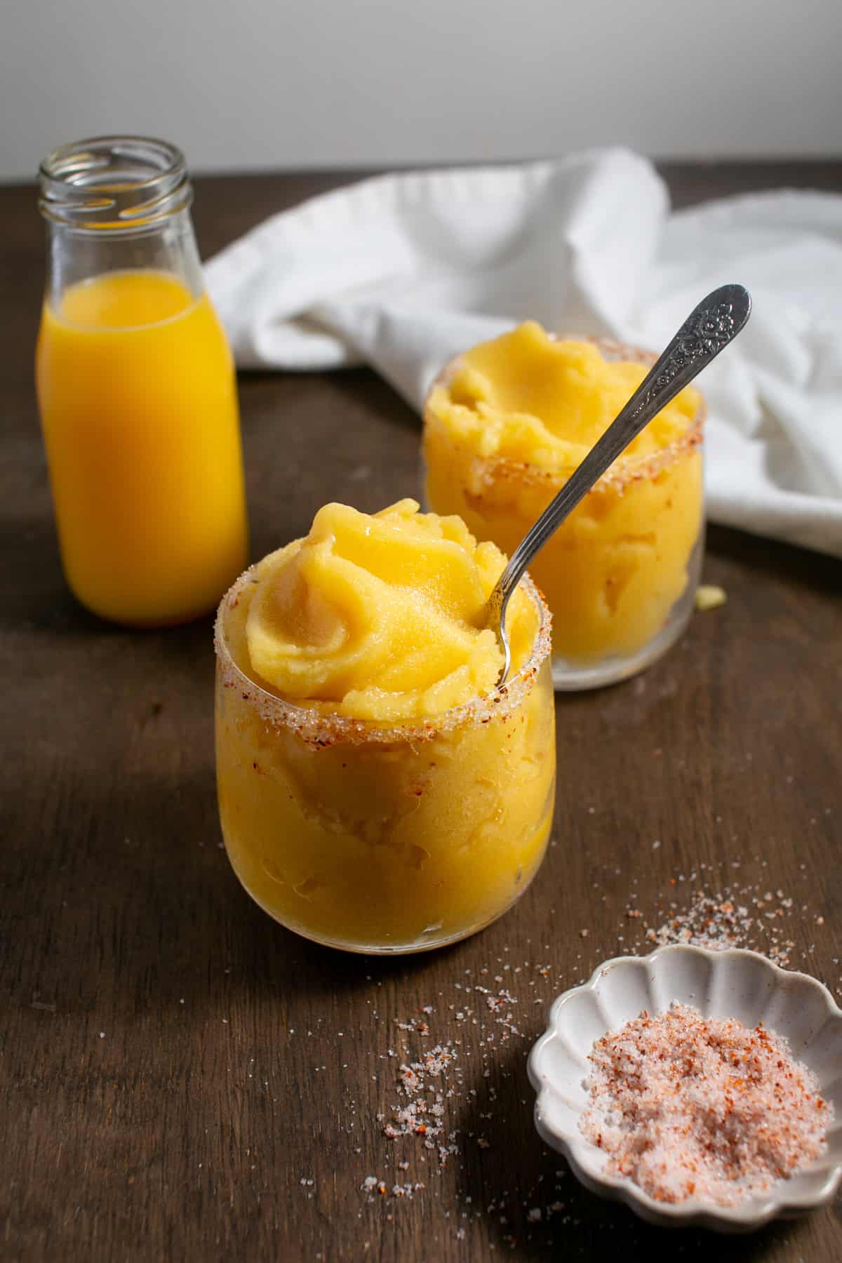 Rosé Peach Sorbet Cocktail in a glass with a tajin rim.