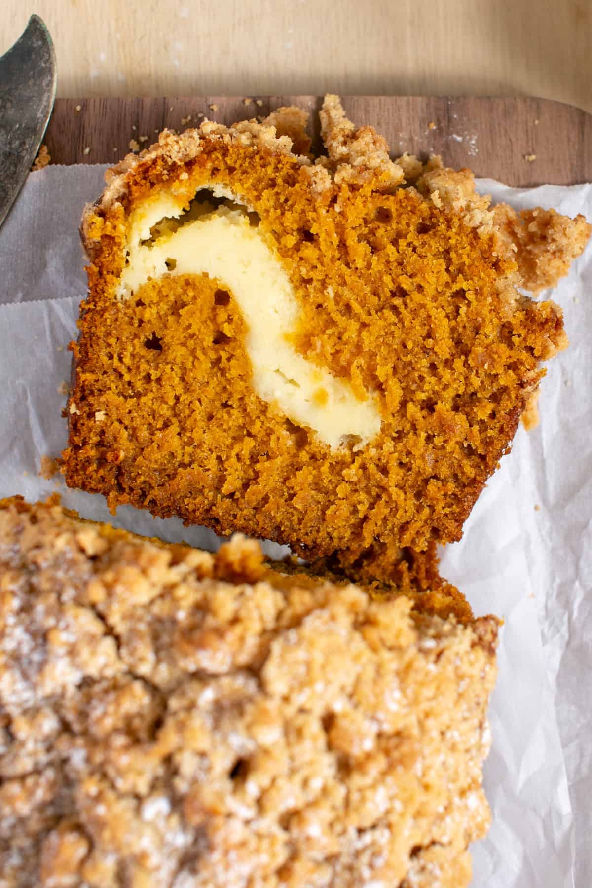 Cream Cheese Pumpkin Bread sliced on a cutting board.