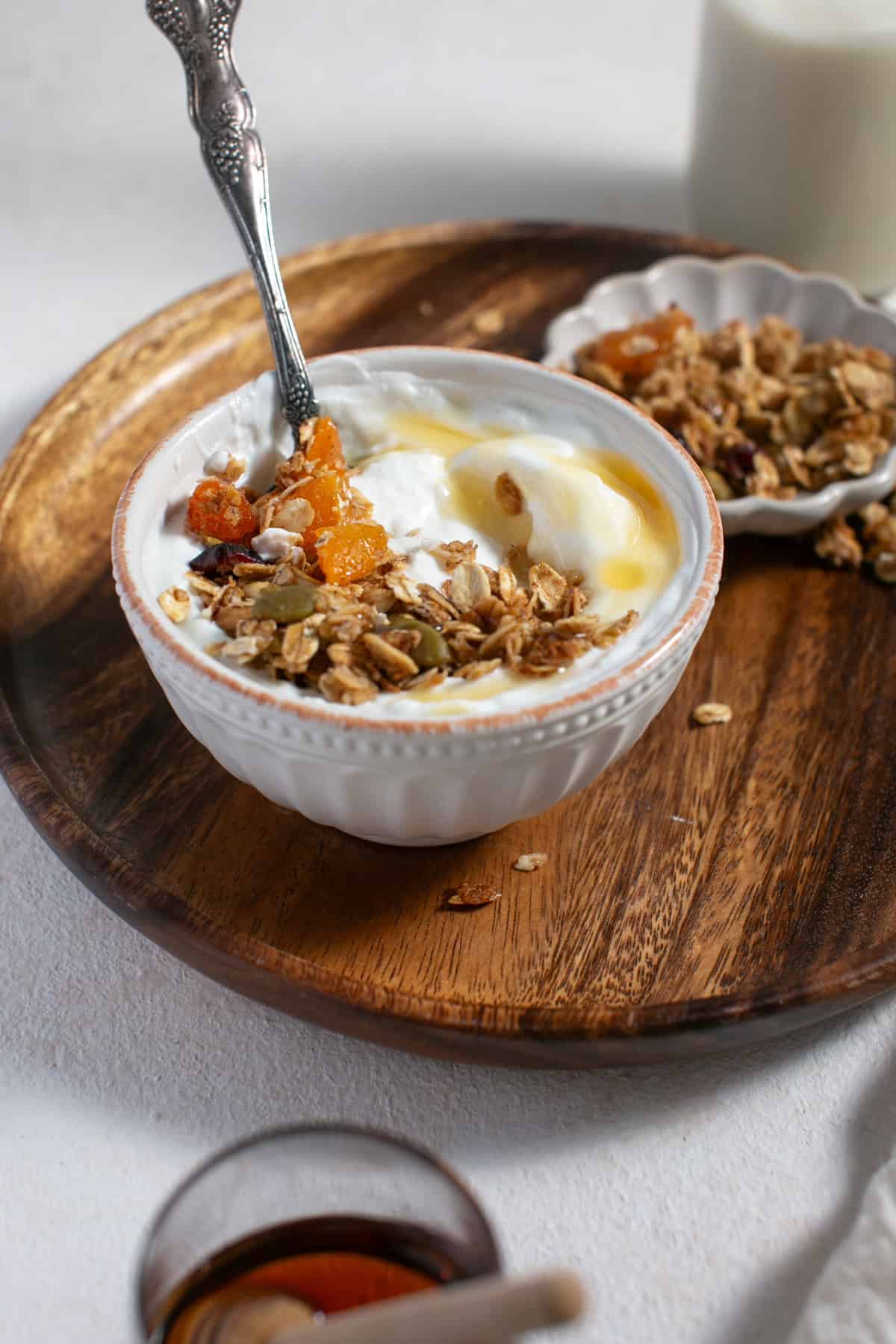 Homemade Pumpkin Spice Granola recipe with a drizzle of honey. 