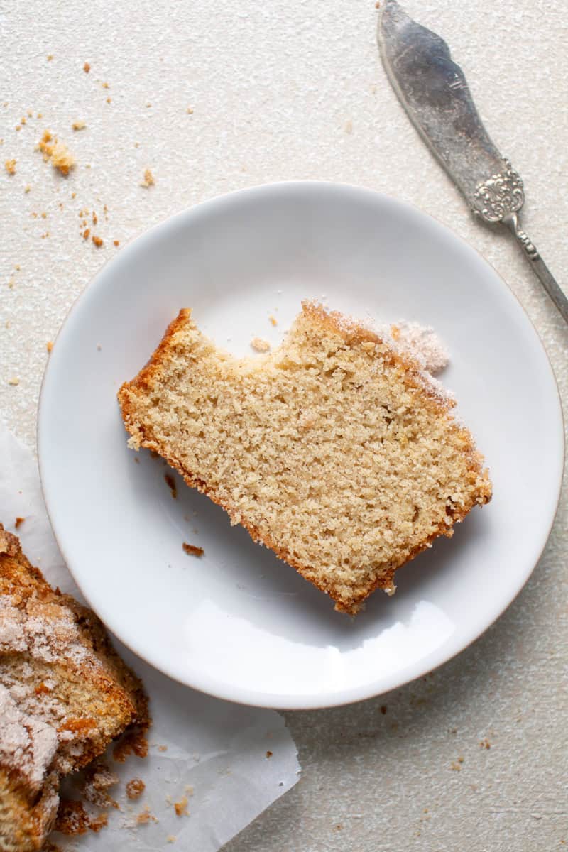 Apple Cider loaf on a plate with a bite missing.