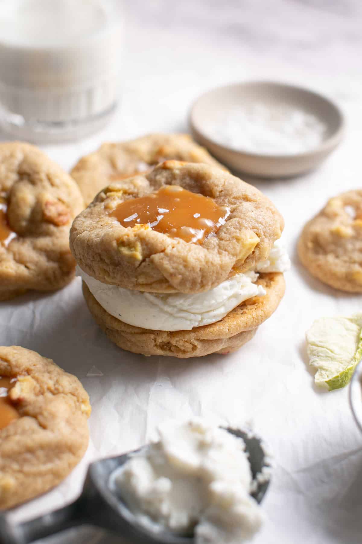 Caramel Apple Cookie Ice Cream Sandwich sitting beside an ice cream scoop.