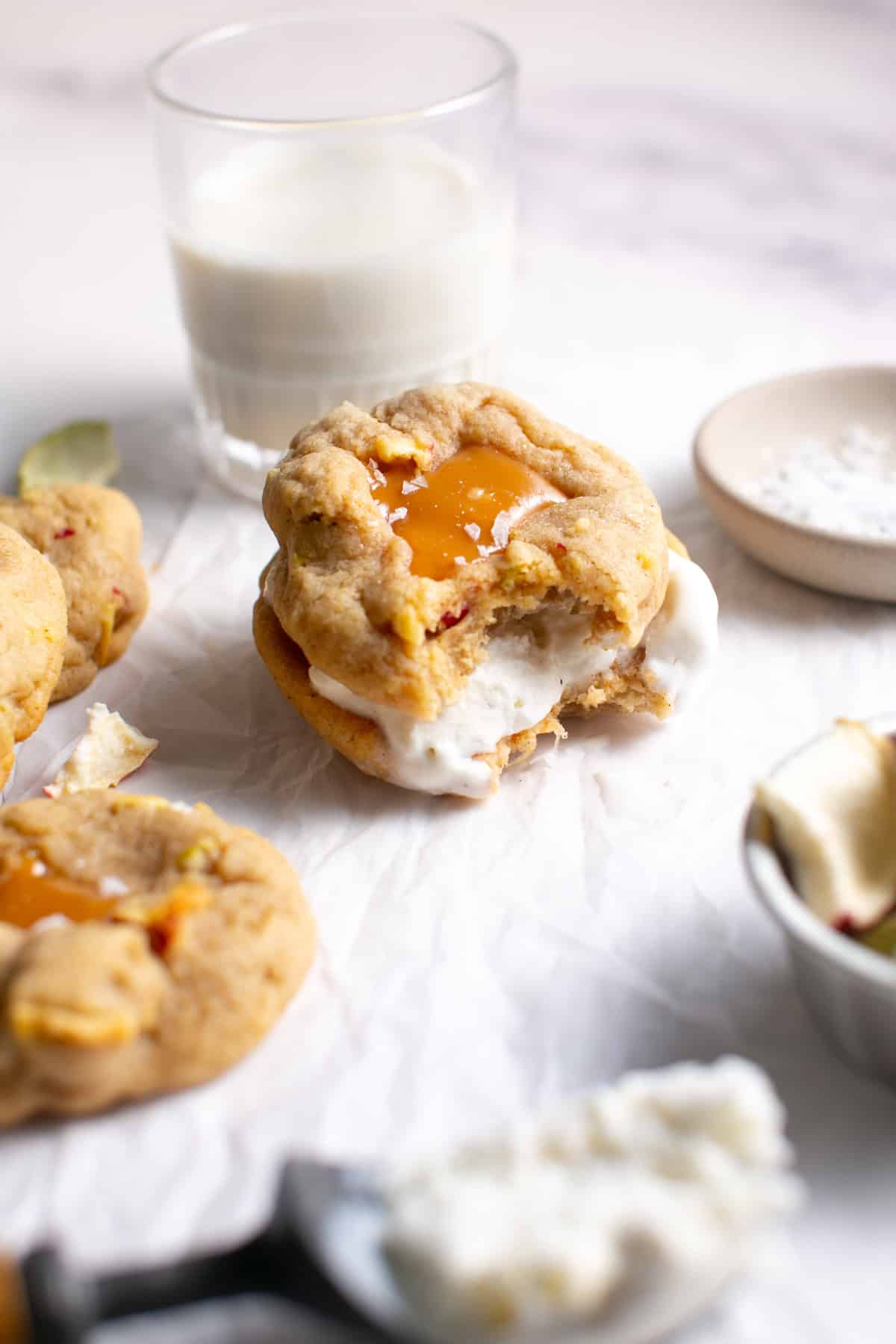 Caramel Apple Cookie Ice Cream Sandwich with a bite missing. 