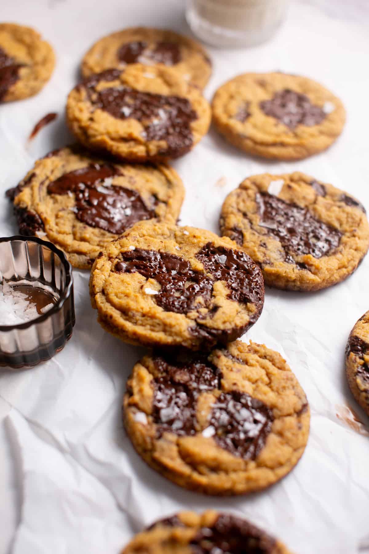 Thick and Chewy Pumpkin Dark Chocolate Chunk Cookies stacked on each other.