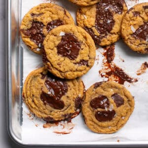 Thick and Chewy Pumpkin Dark Chocolate Chunk Cookies on a sheet pan.