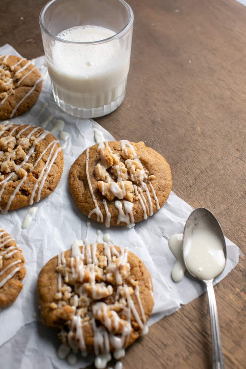 Pumpkin Coffee Cake Cookies sitting by a glass of milk.