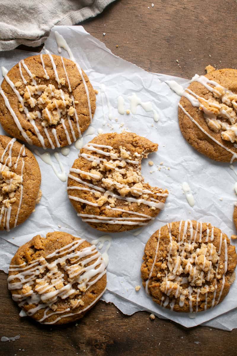 Pumpkin Coffee Cake Cookies with a bite missing on parchment paper. 