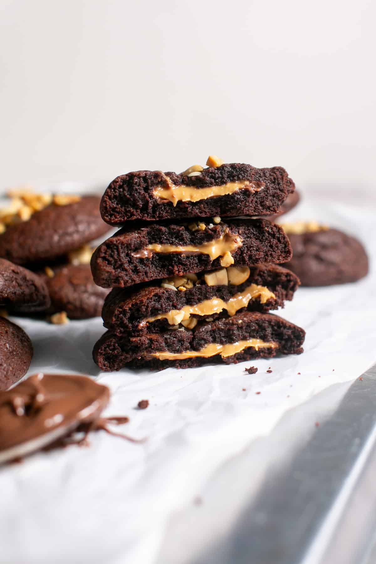 Peanut Butter Nutella Stuffed Cookie broken in half and stacked on each other. 