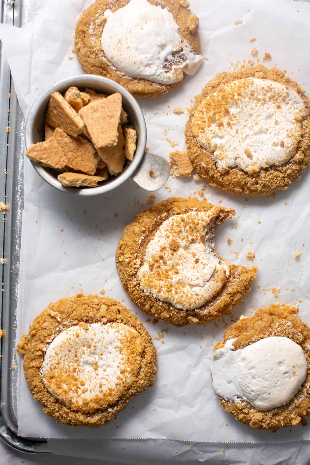 Marshmallow Fluff Cookies by a bowl of graham cracker pieces. 