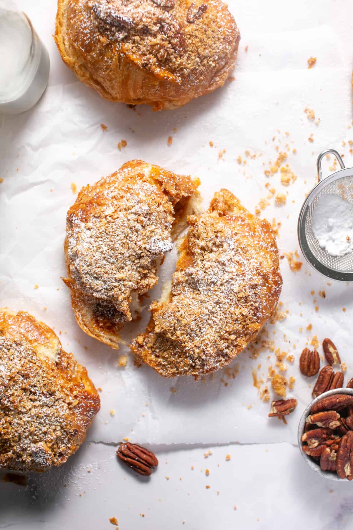 Pumpkin Pie Croissants broken in half with powdered sugar on the top. 