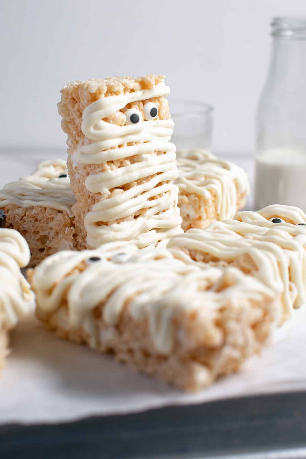 Halloween Mummy Rice Krispie Treats  stacked on each other. 