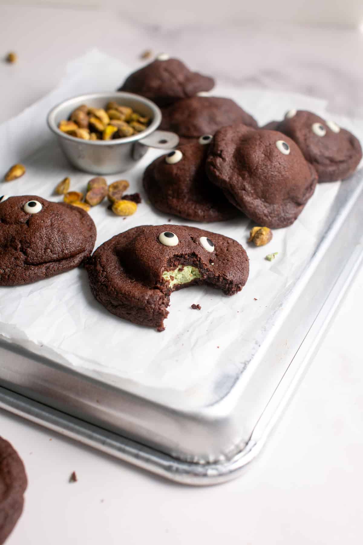 White Chocolate Pistachio Stuffed Cookie Recipe with a bite missing. 