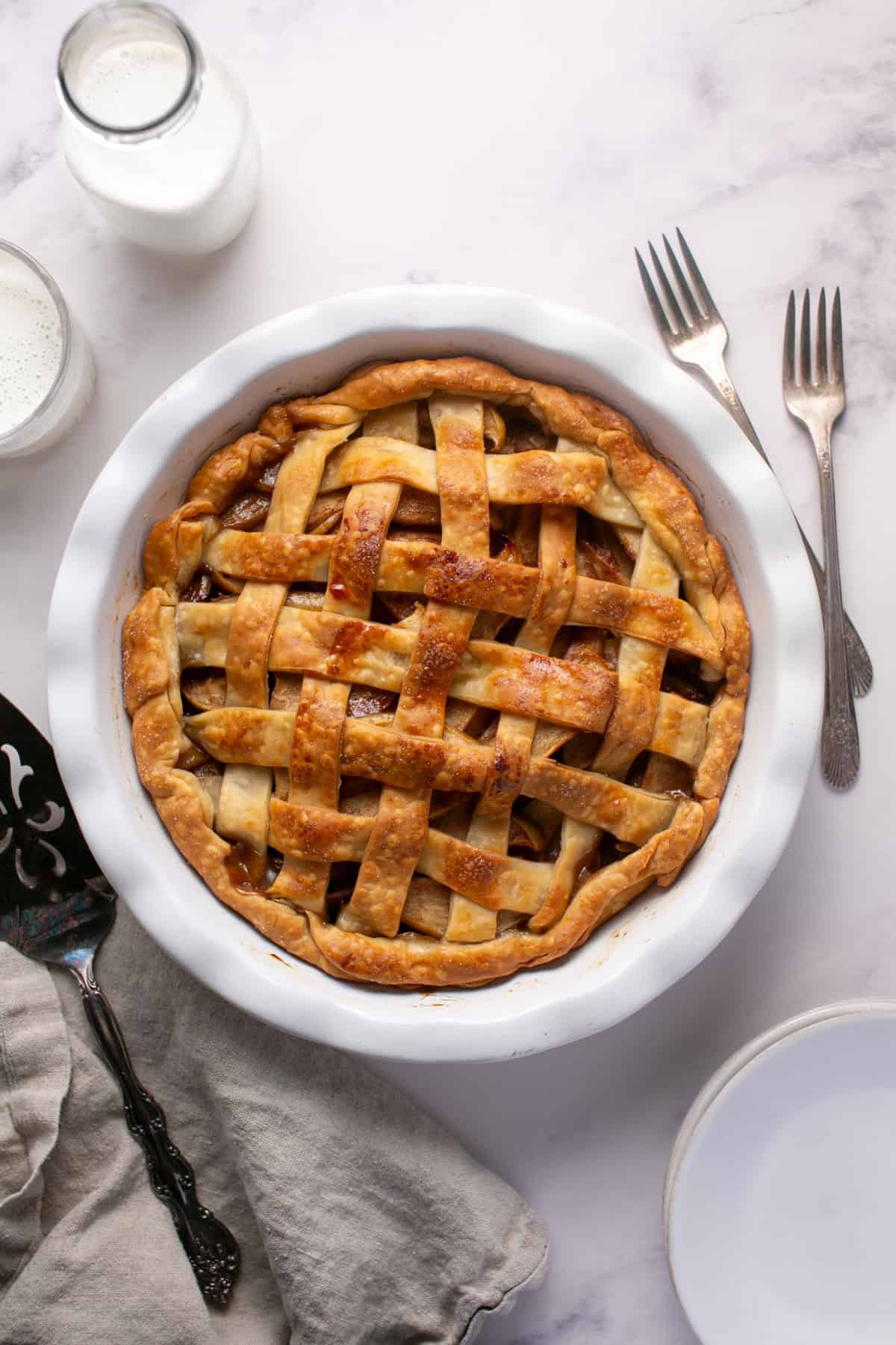 Easy Holiday Apple Pie sitting by small plates.