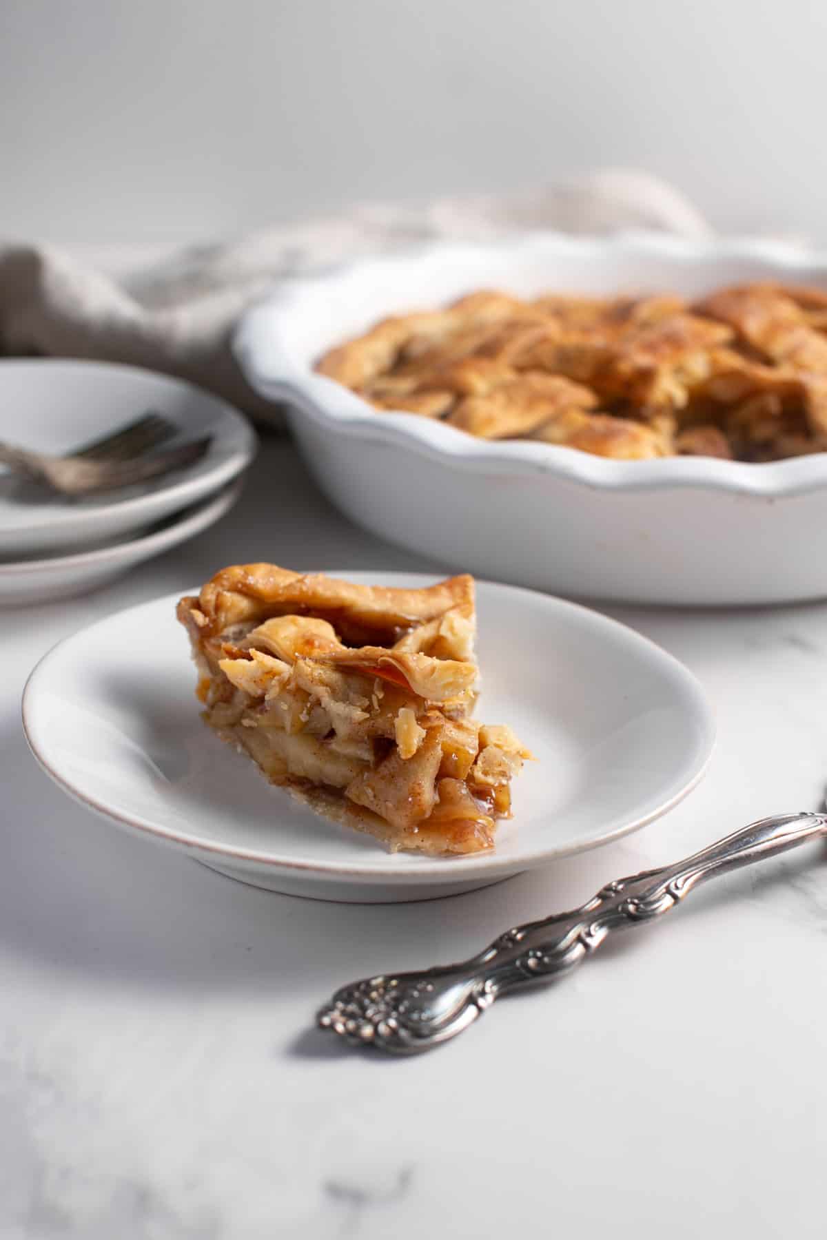 Easy Holiday Apple Pie cutting out a slice. 