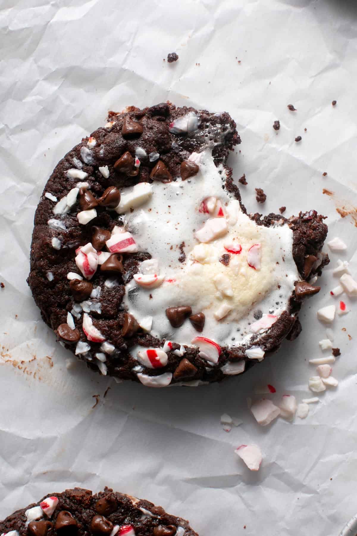 Peppermint Marshmallow Hot Chocolate Cookies with a bite missing.