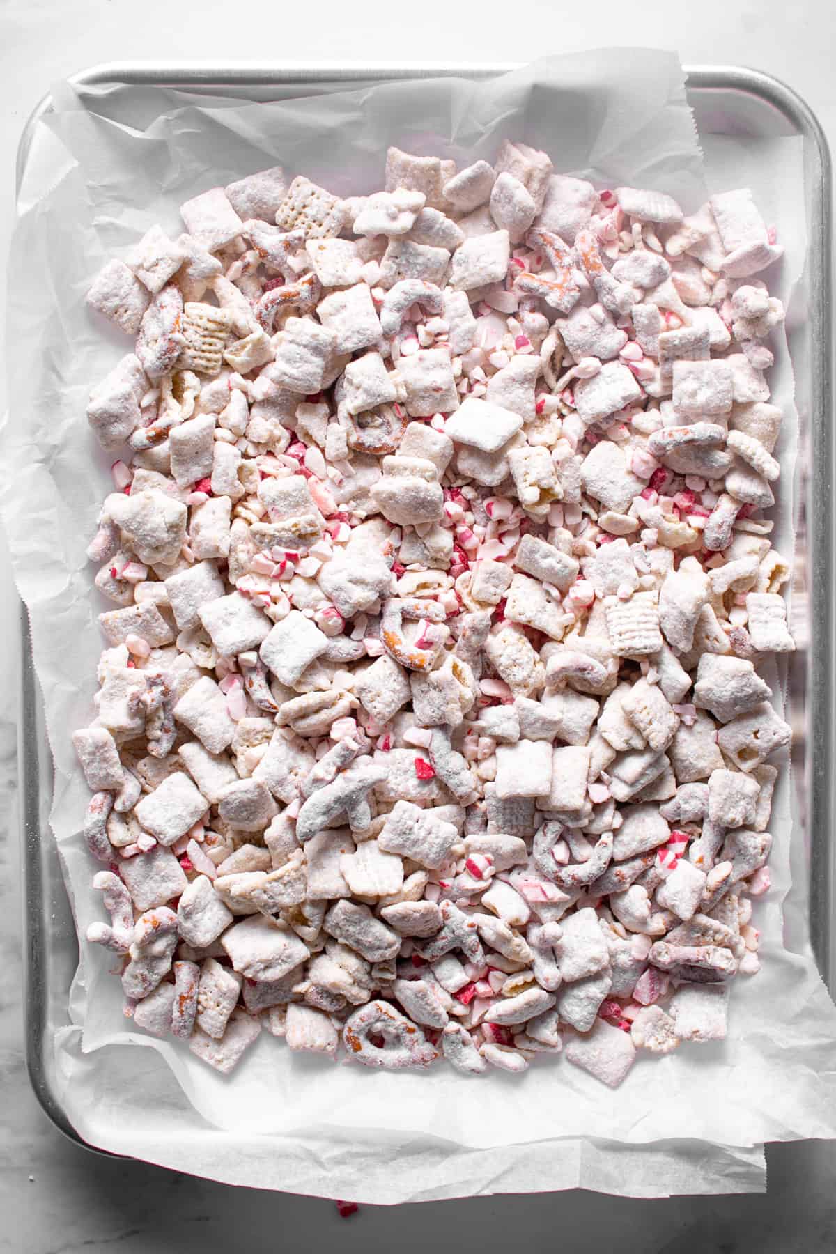 White Chocolate Peppermint Puppy Chow on a baking sheet. 