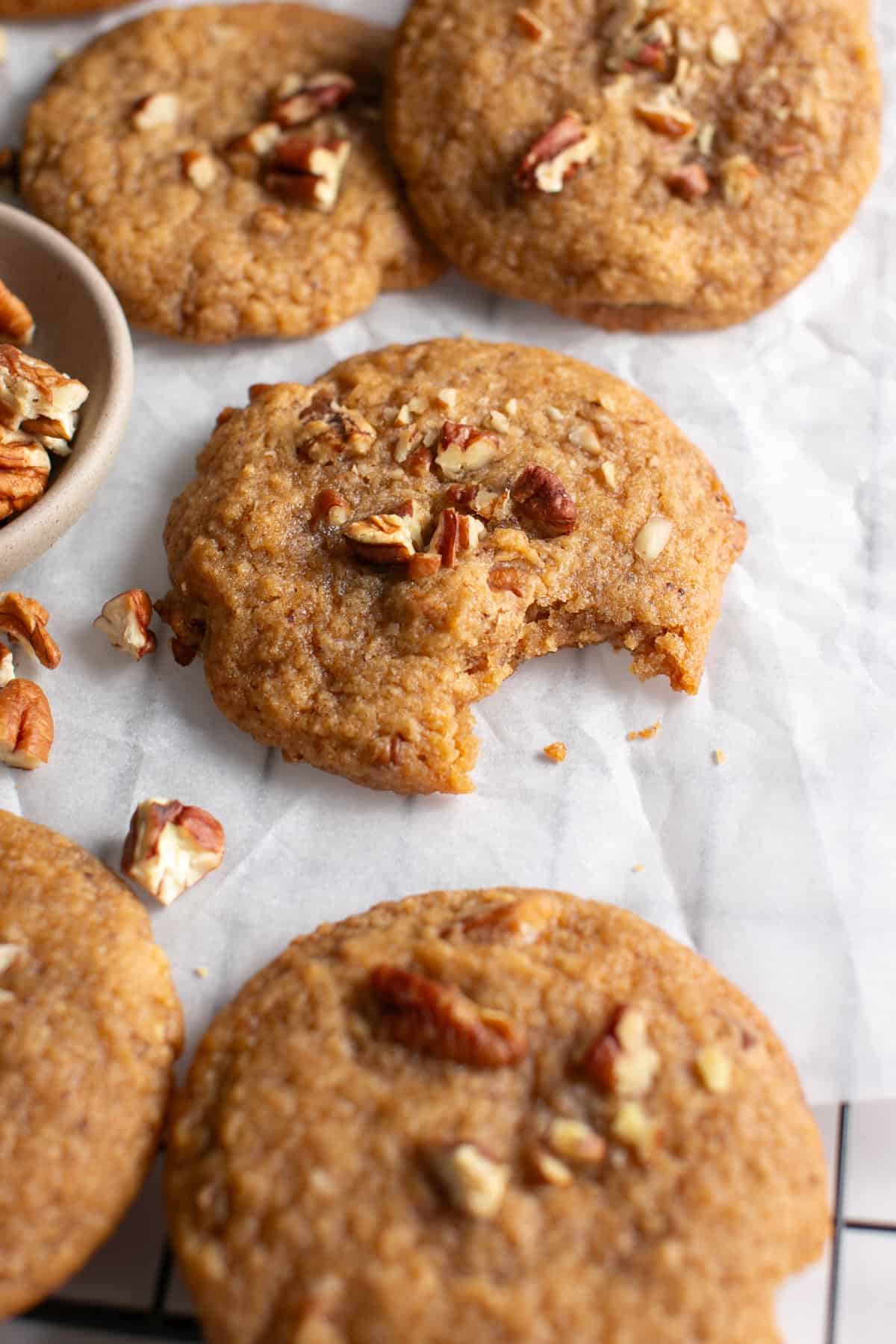 Brown Butter Apple Butter Cookies with Pecans with a bite missing.