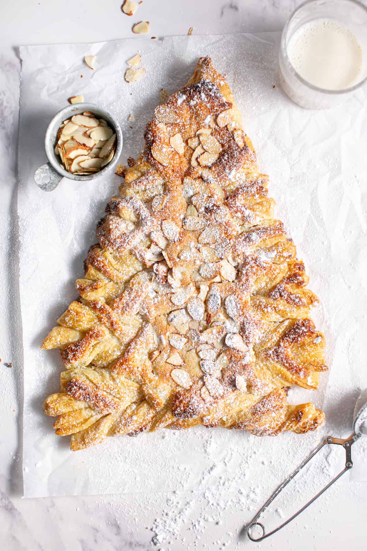 Almond Croissant Puff Pastry Christmas Tree on parchment paper. 