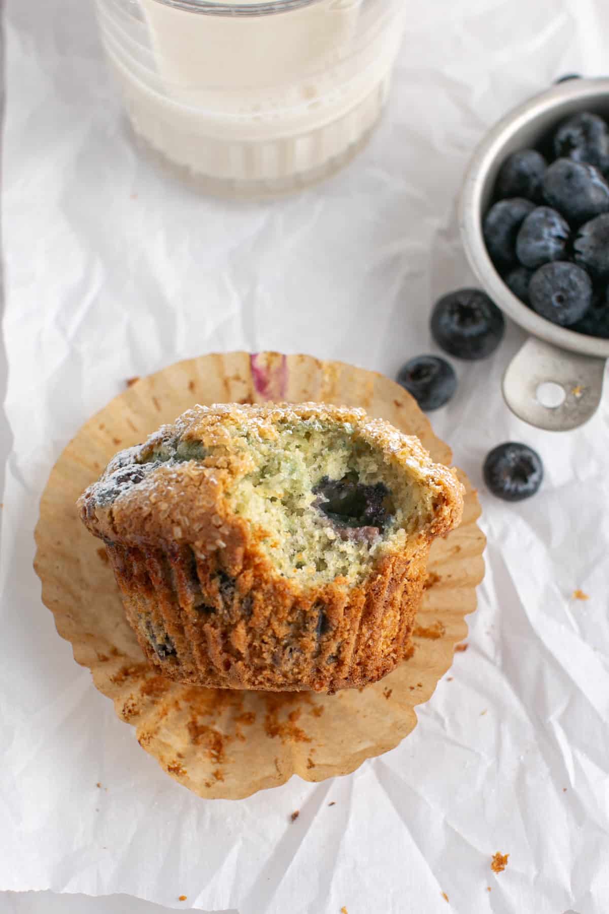 Single Serve Blueberry Muffin by a glass of milk. 