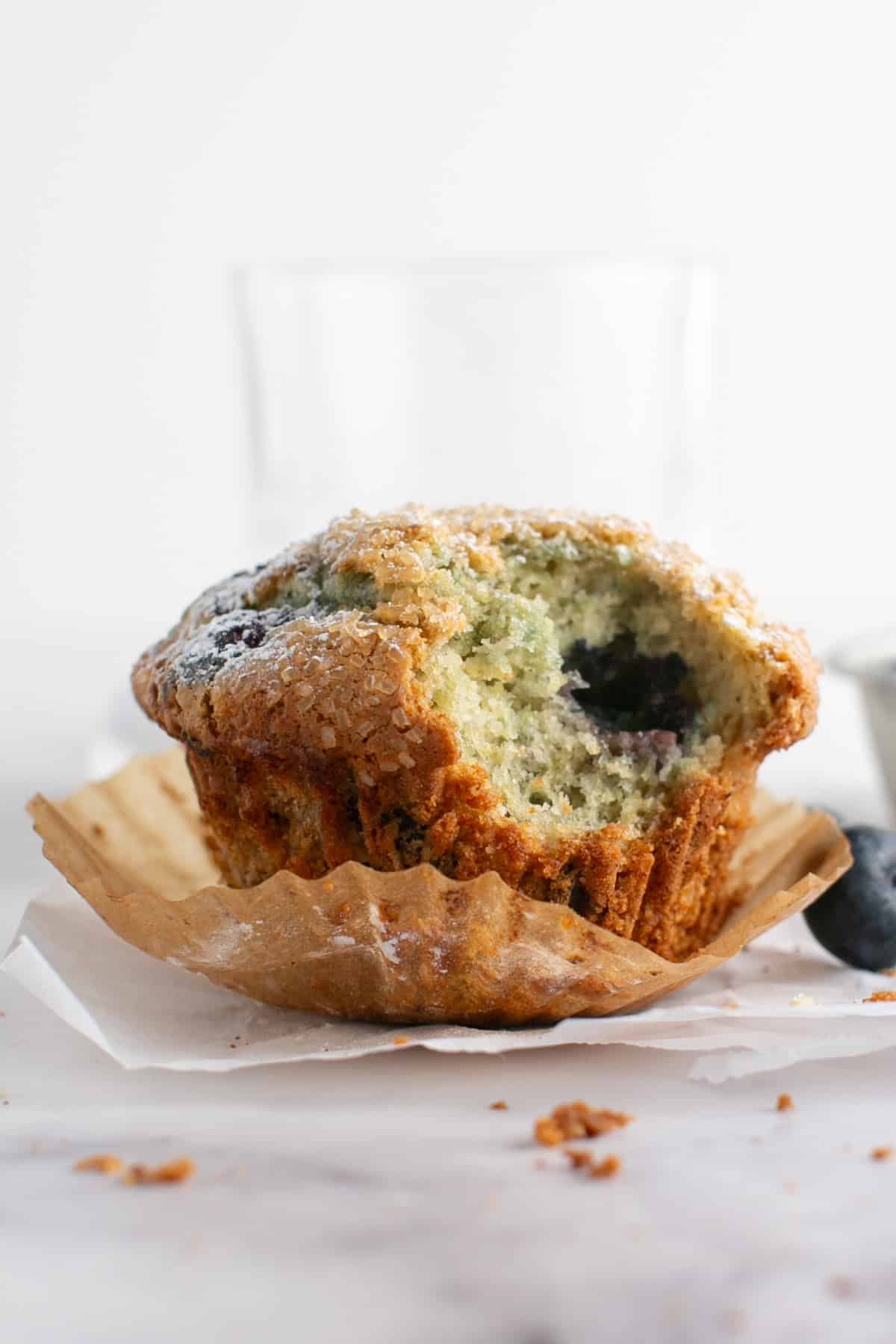 Single Serve Blueberry Muffin with a bite missing. 