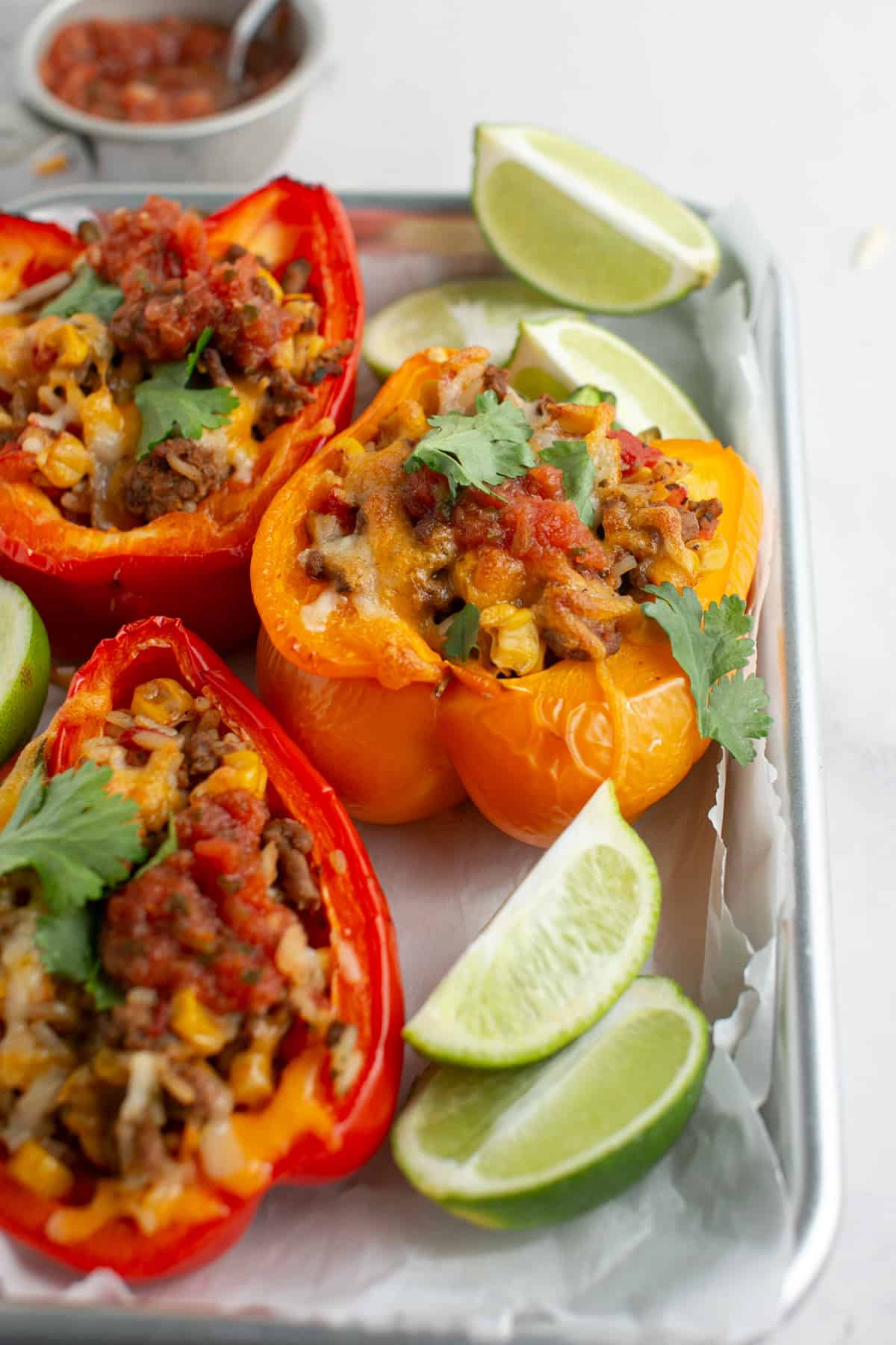 Stuffed peppers on a sheet tray.