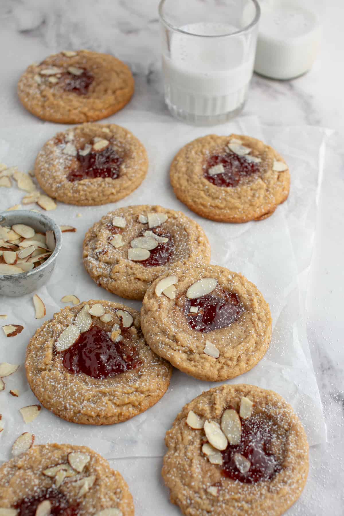 Almond Butter and Jelly Thumbprint Cookie on parchment paper.