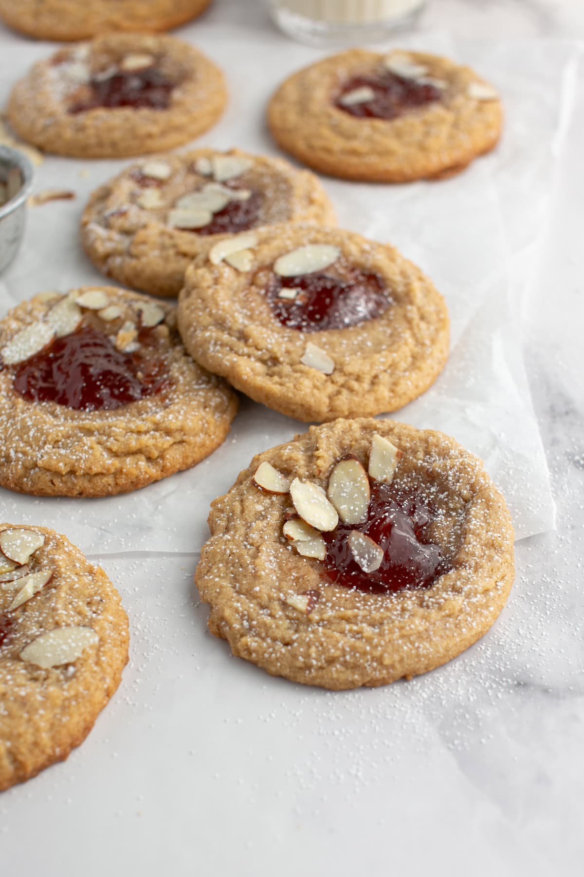 Almond Butter and Jelly Thumbprint Cookie with a sprinkle of powdered sugar.