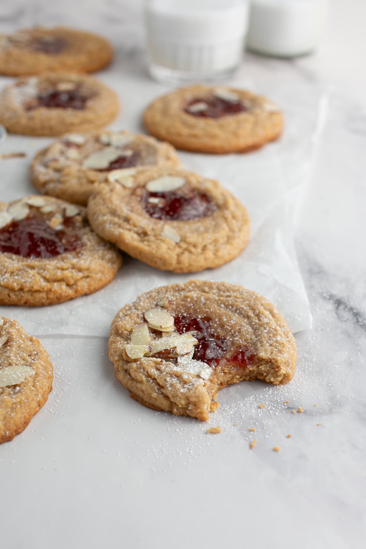 Almond Butter and Jelly Thumbprint Cookie by a glass of milk.