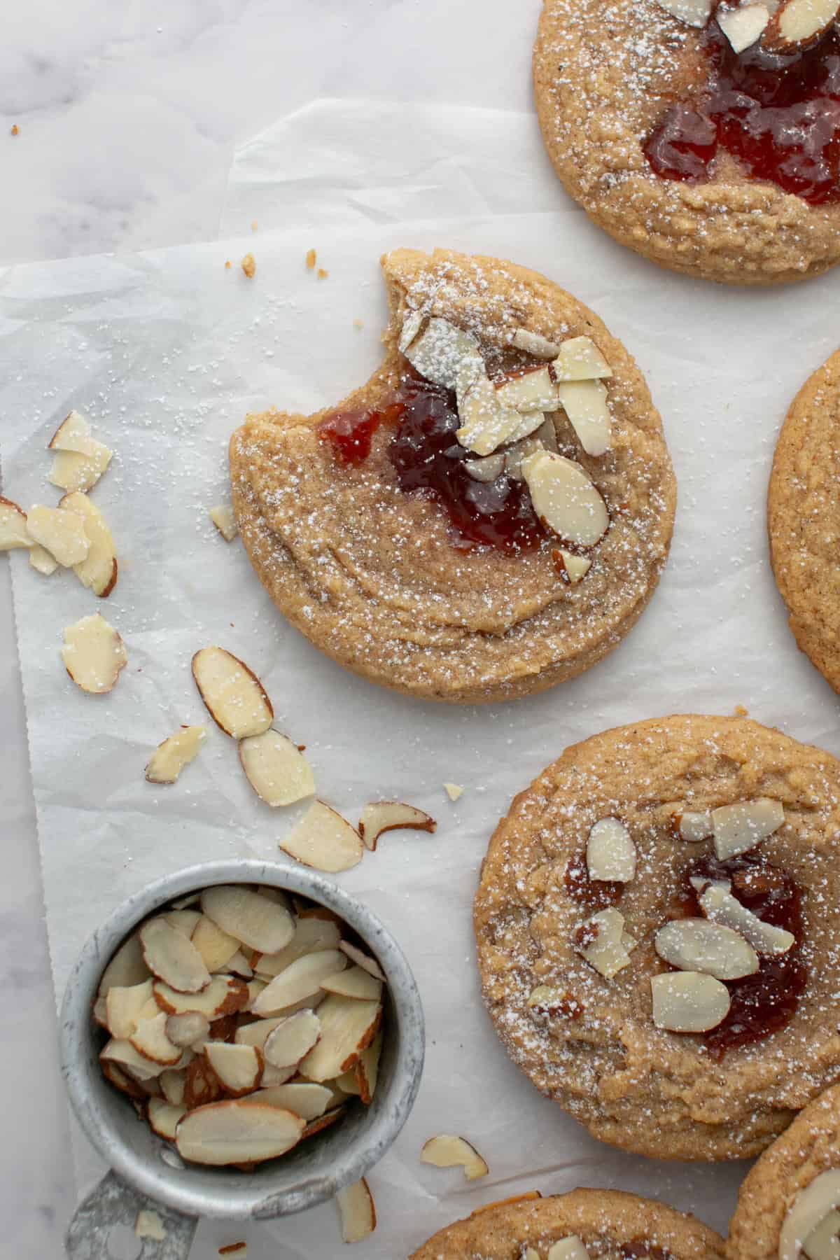 Almond Butter and Jelly Thumbprint Cookie with a bite missing.