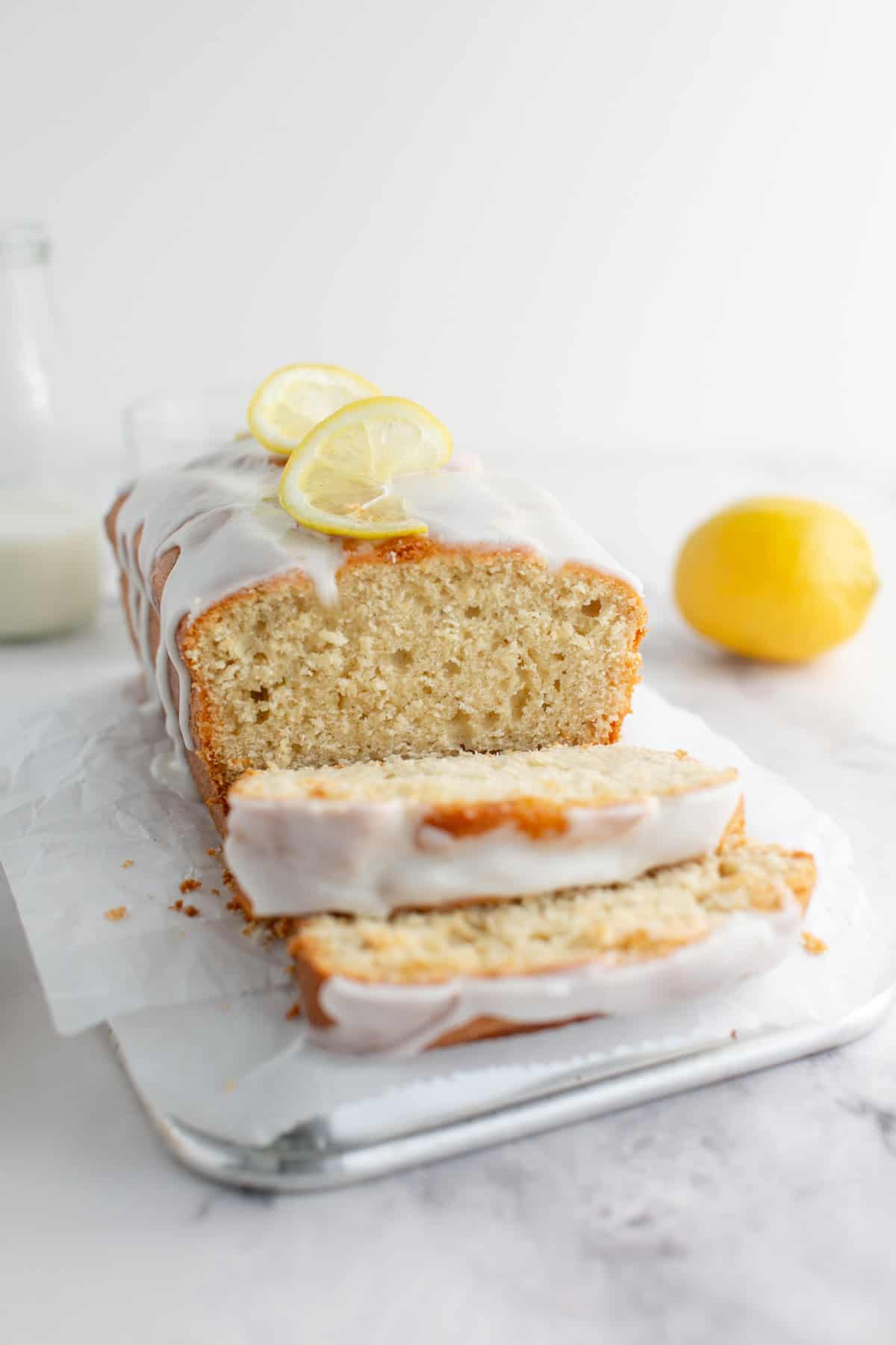 Earl Grey Tea Loaf Cake sliced on parchment paper.