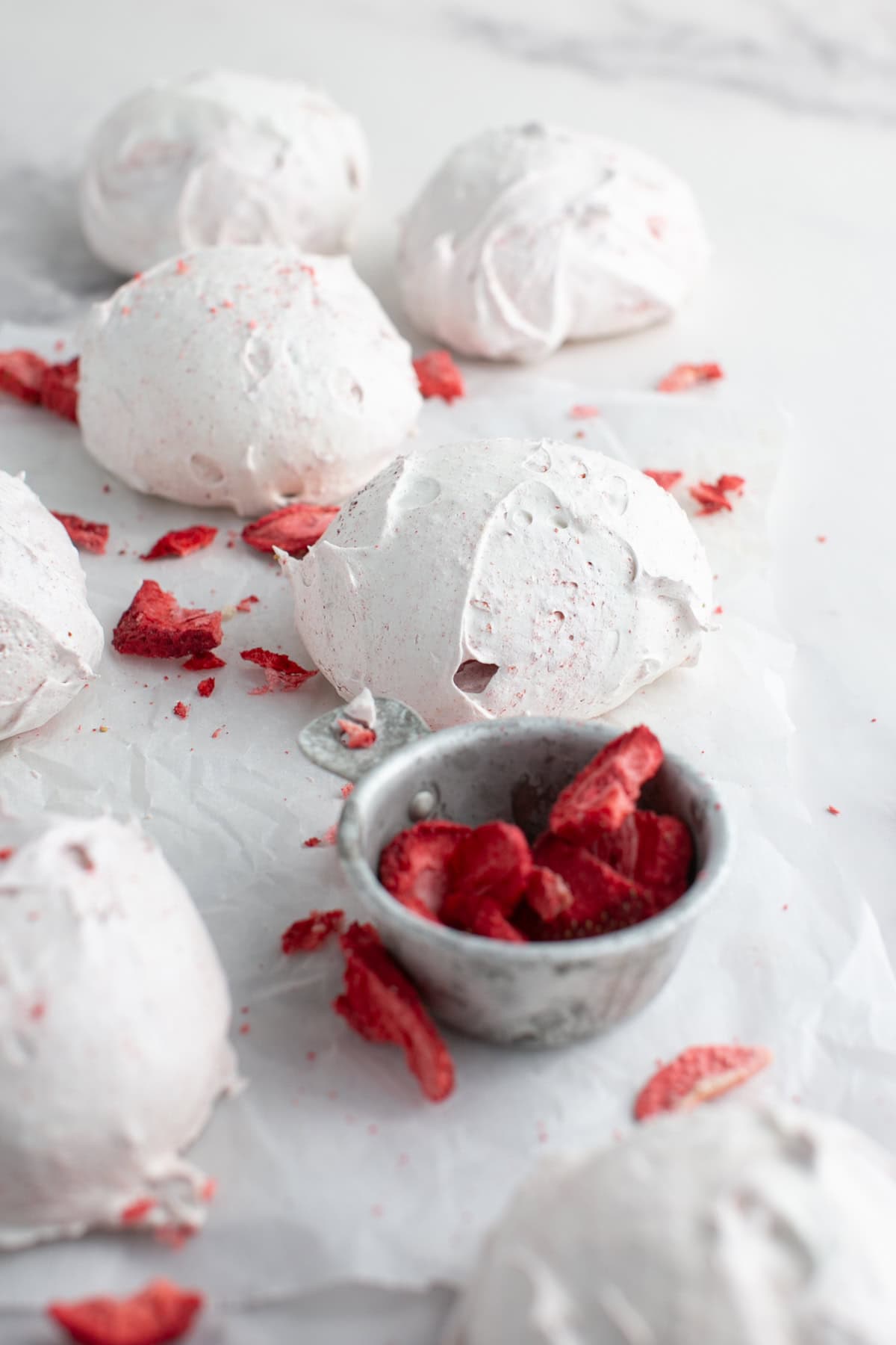 Strawberry Meringue Cloud Cookies on parchment paper.