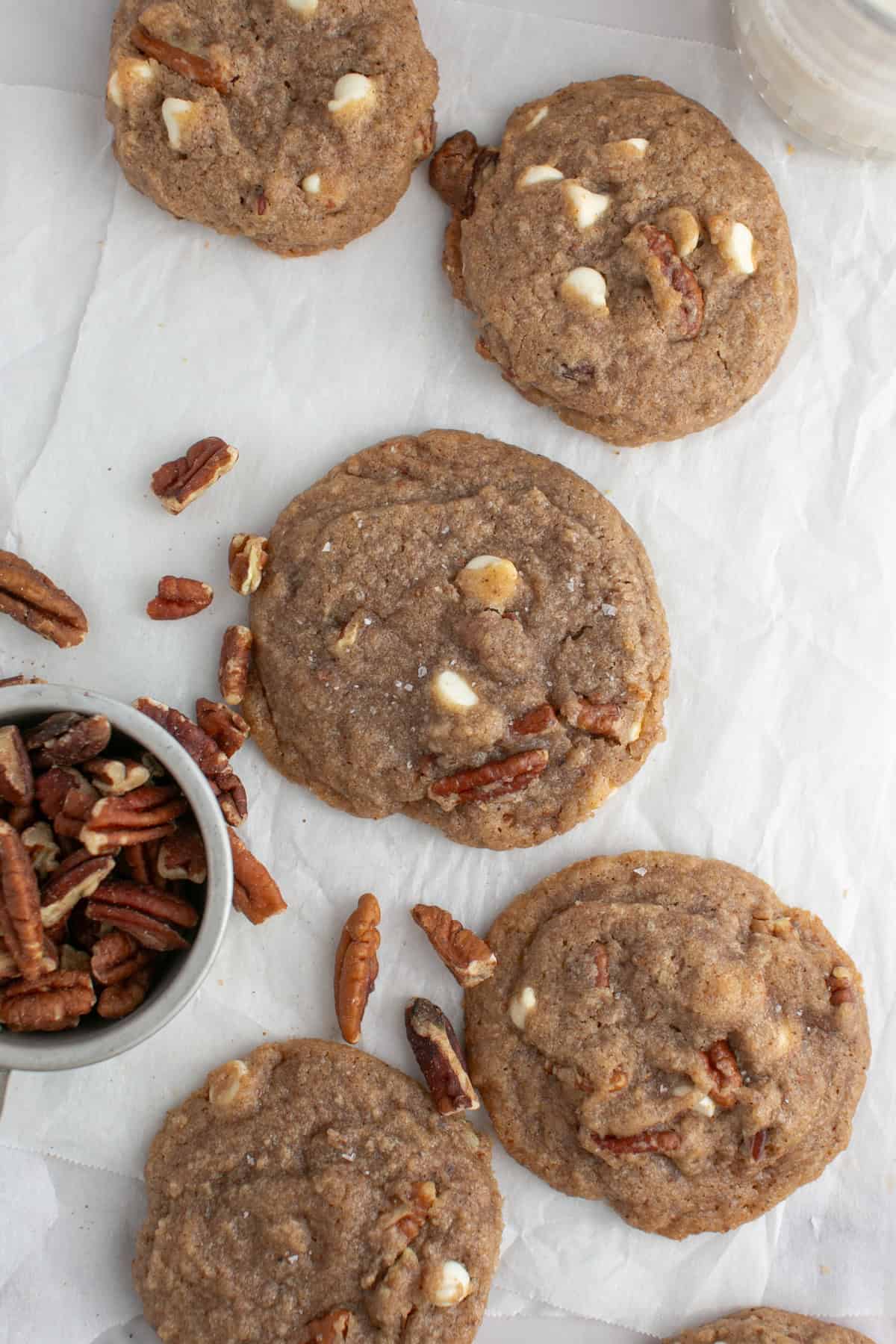 Brown Butter Chai Cookie with a bowl of pecans.