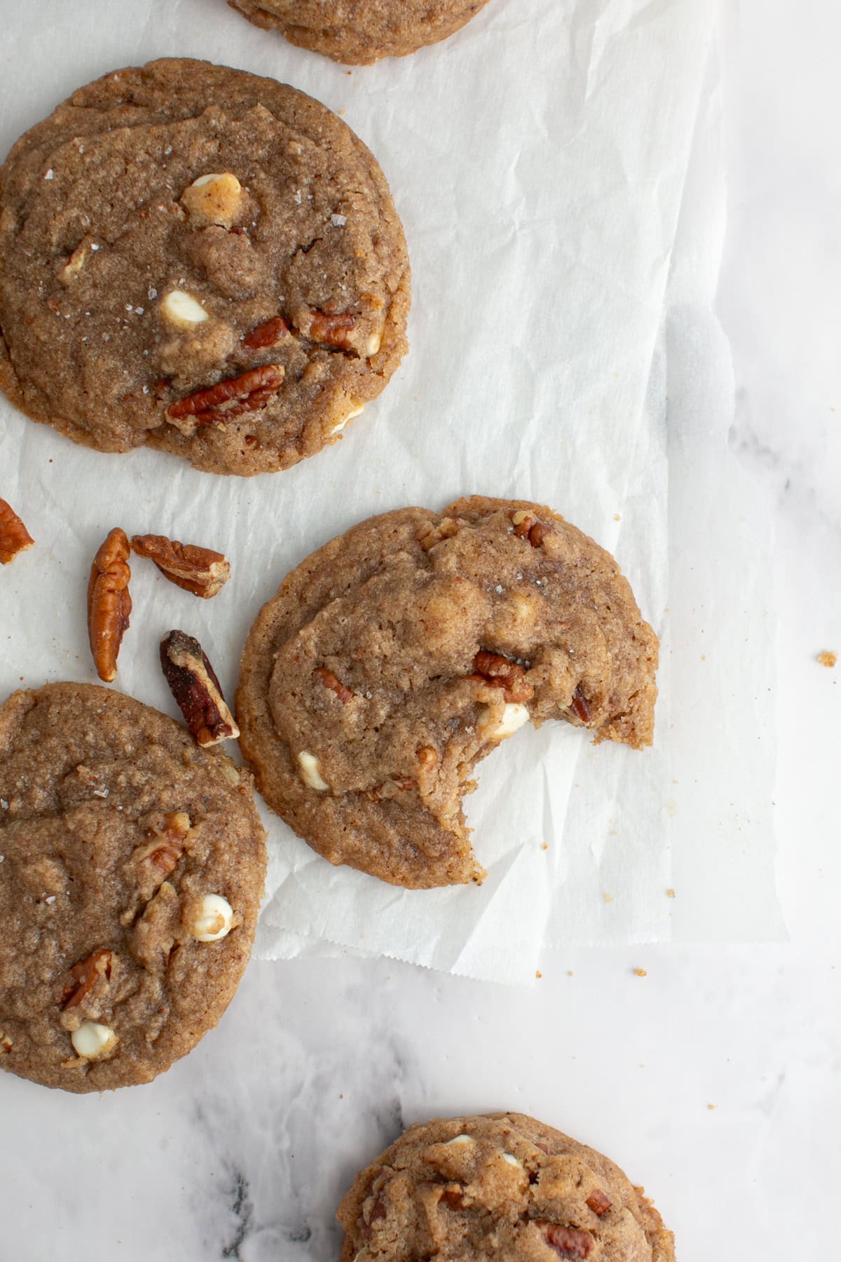 Brown Butter Chai Cookie with a bite missing and crumbs.