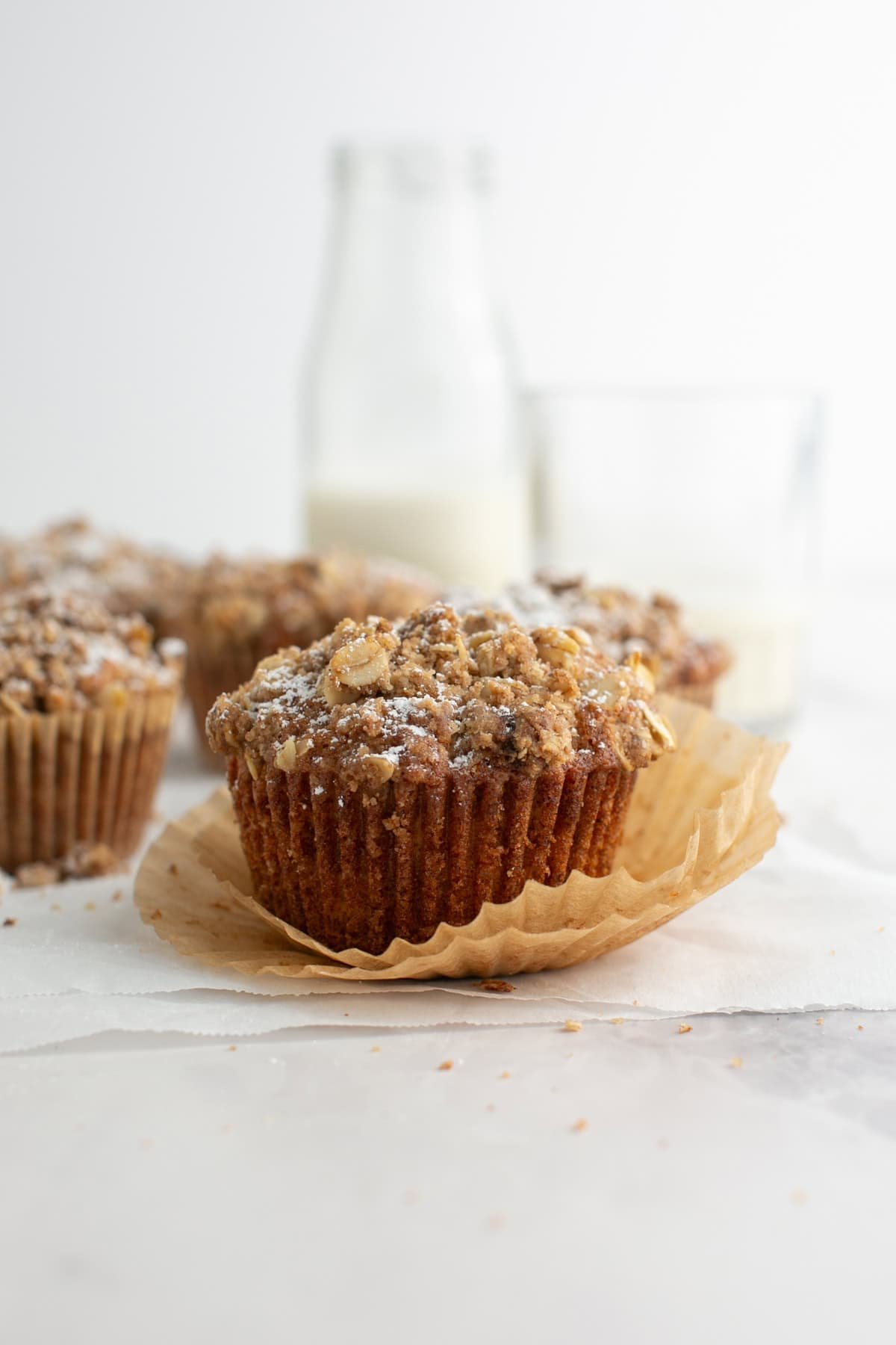 Cinnamon Oatmeal Muffin with an unwrapped muffin liner.