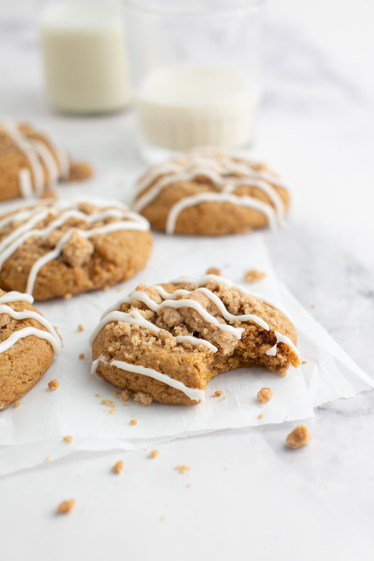 Cake Mix Spiced Pumpkin Coffee Cake Cookies with a bite missing.