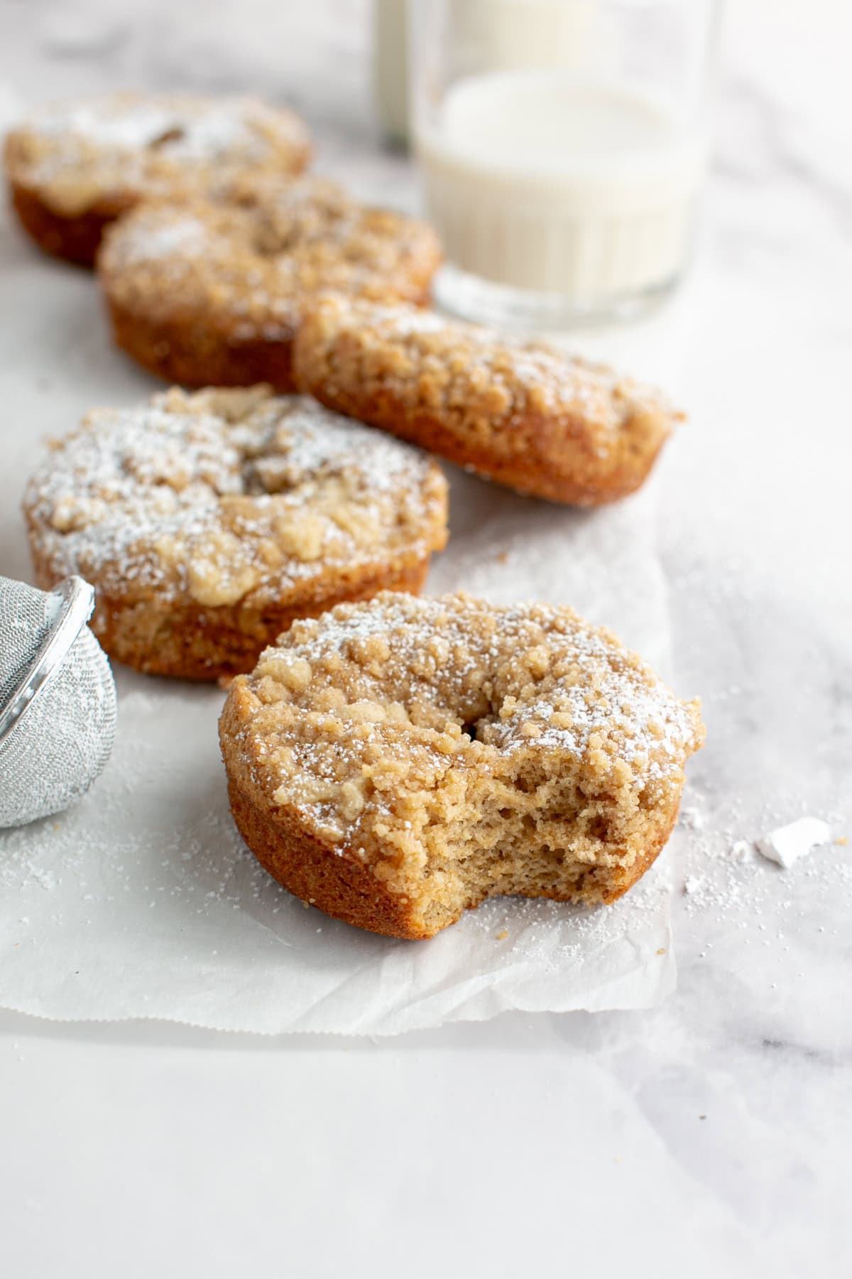 Cinnamon Sugar Crumble Donuts with a bite missing.