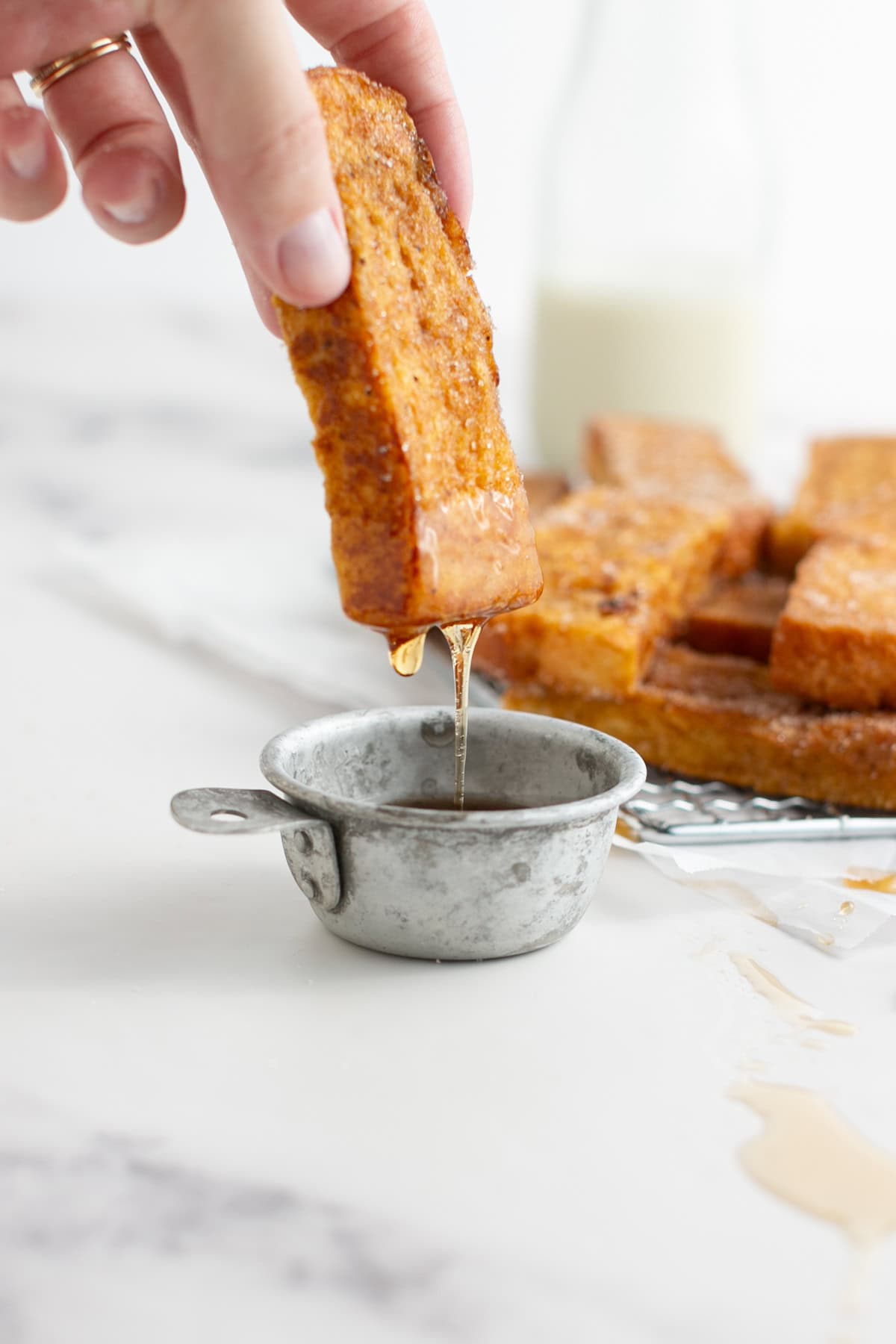 Pumpkin French Toast Sticks dipping into syrup.