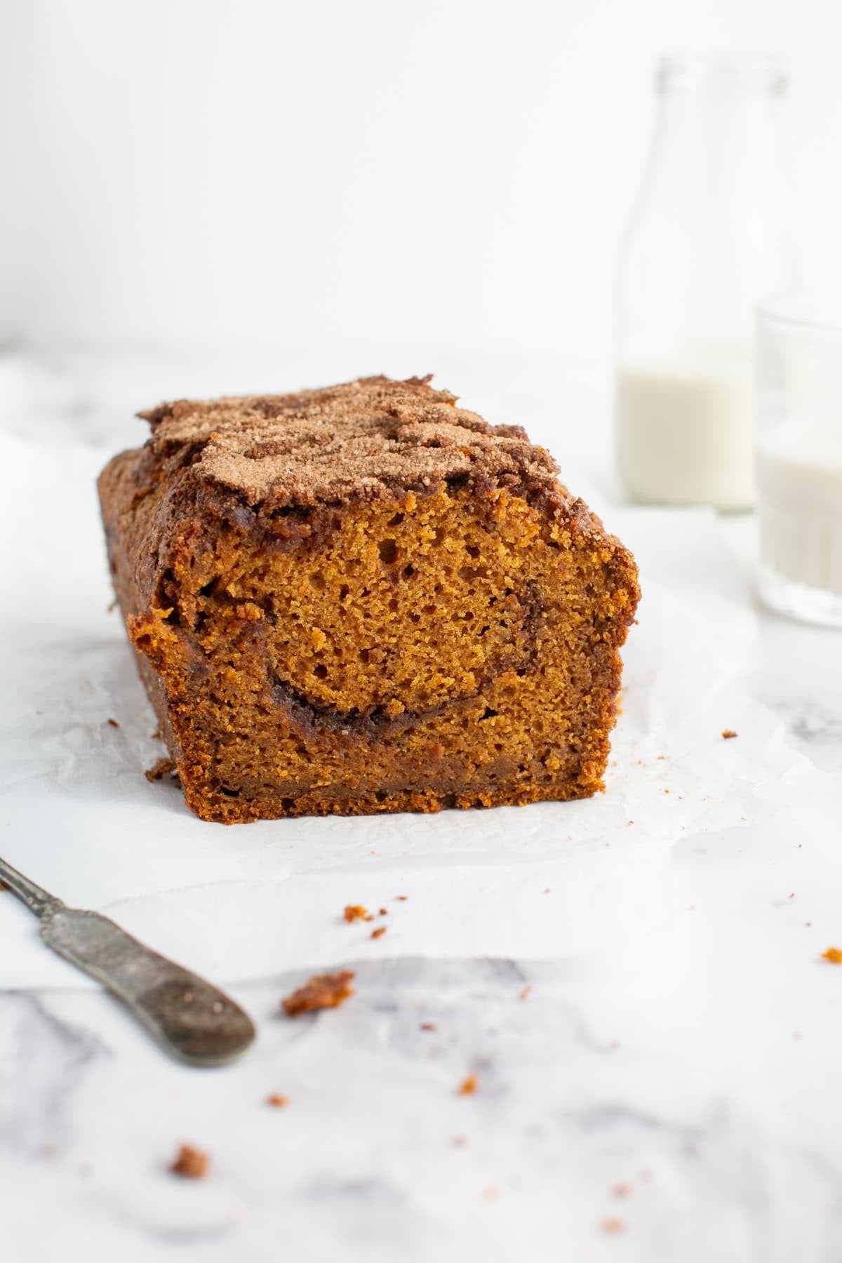 Pumpkin Maple Bread with Cinnamon Swirl Streusel on parchment paper. 