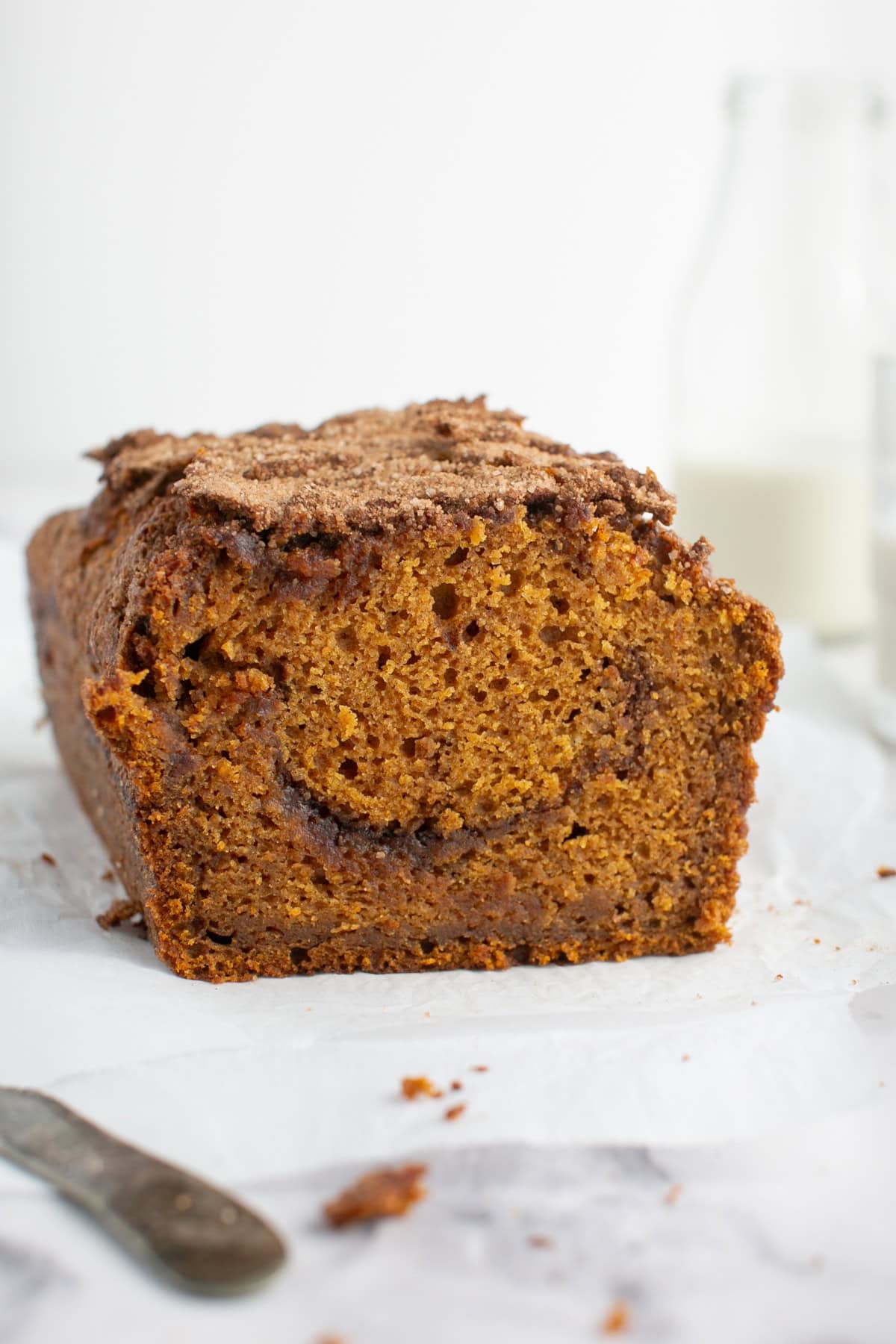 Pumpkin Maple Bread by a glass of milk.