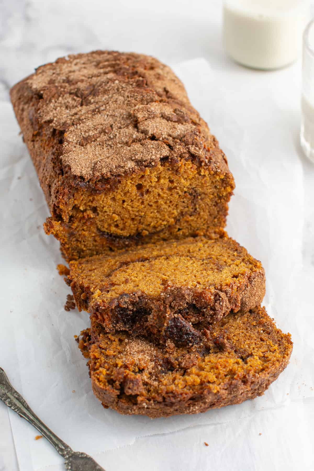 Pumpkin Maple Bread sliced on parchment paper. 