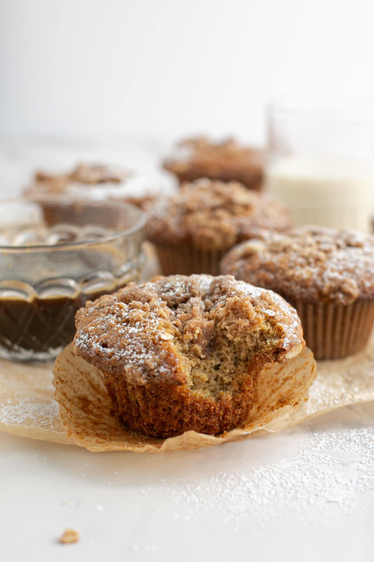 Chai Spiced Oat Crumble Muffins with a bite missing.