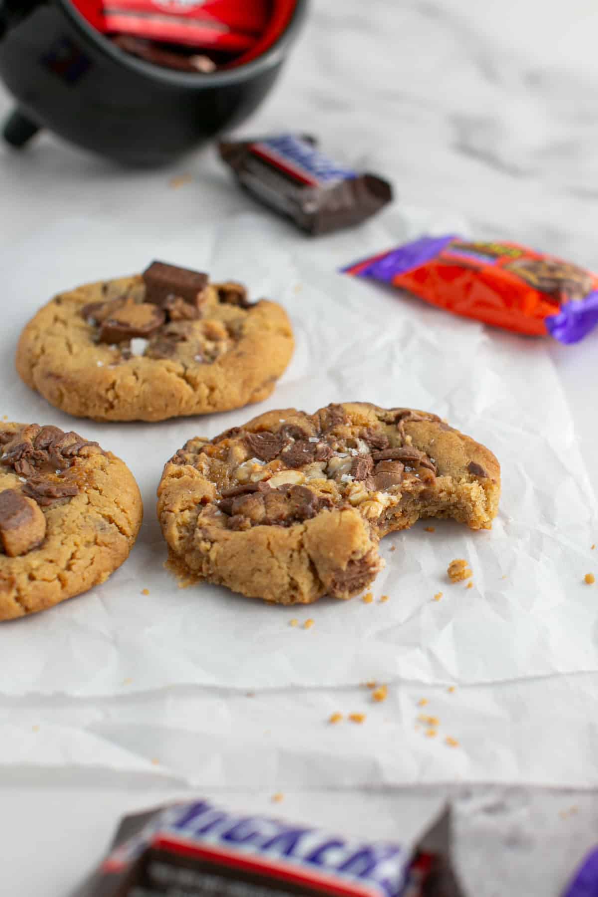 Single Serve Peanut Butter Candy Cookies with a bite missing.