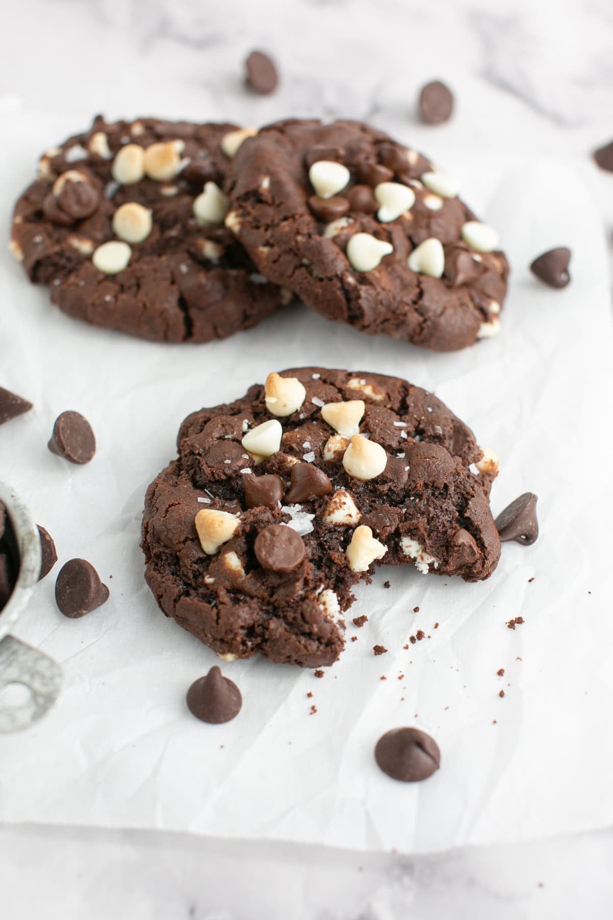 Triple Chocolate Chunk Cookie with a bite missing.