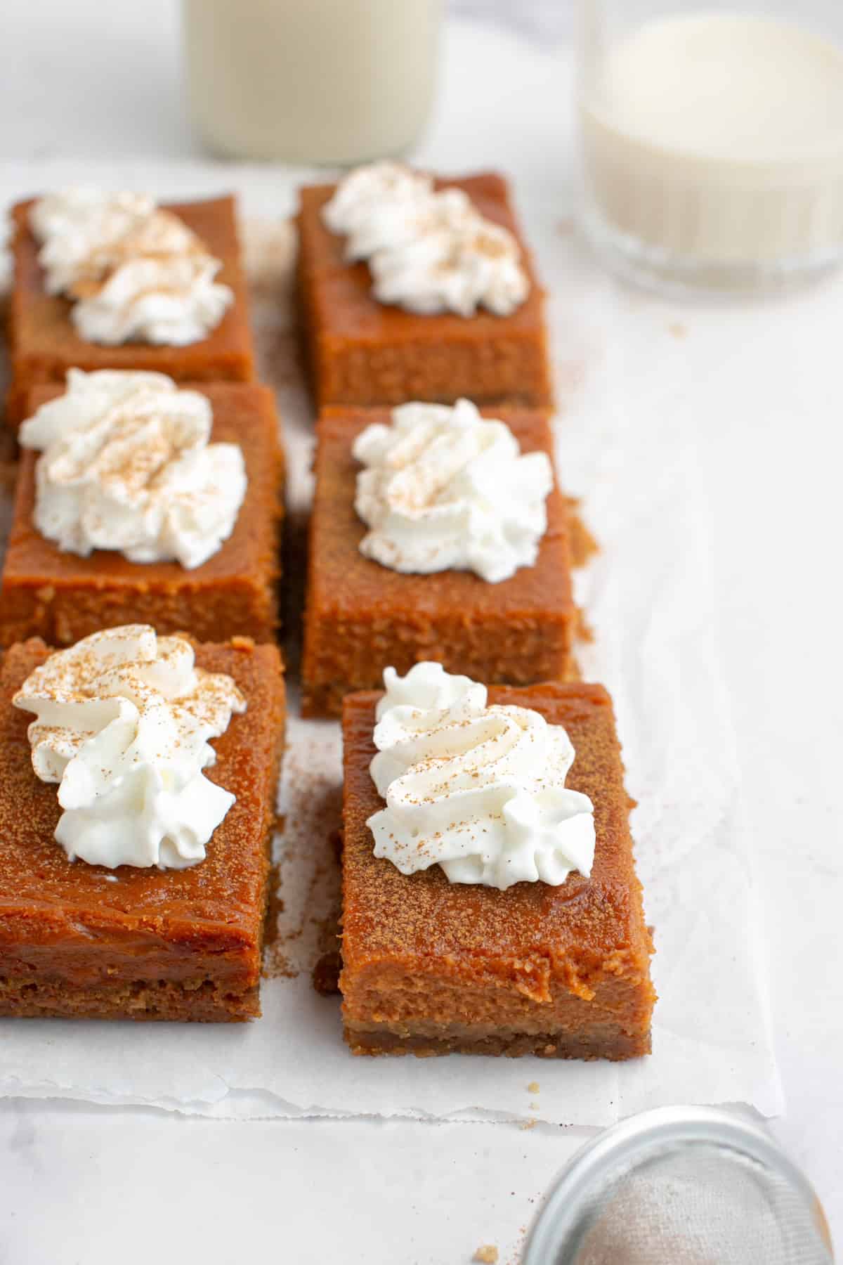 Pumpkin Pie Bars with a glass of milk.