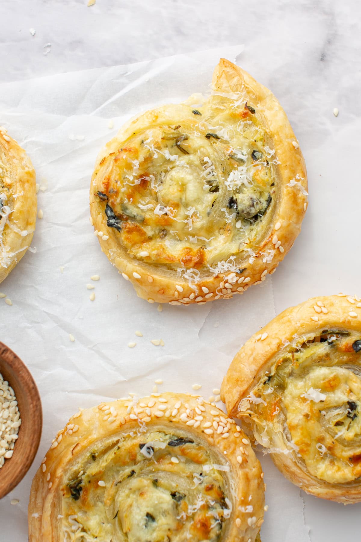 Spinach Artichoke Puff Pastry Appetizer with sesame seeds.