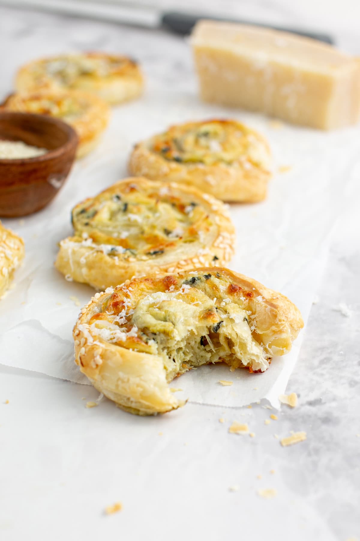 Spinach Artichoke Puff Pastry Appetizer with a bite missing.