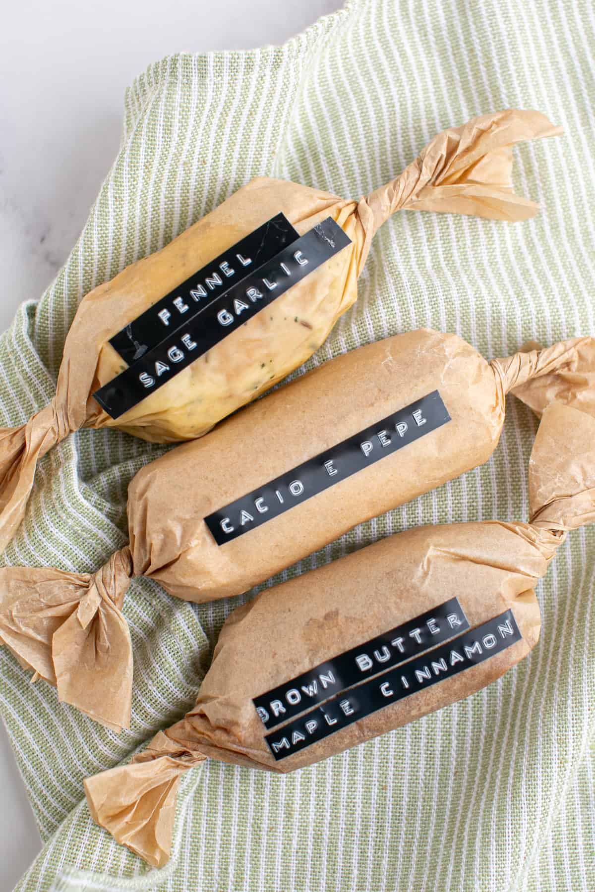 Homemade Compound Butter Recipes wrapped in parchment paper.