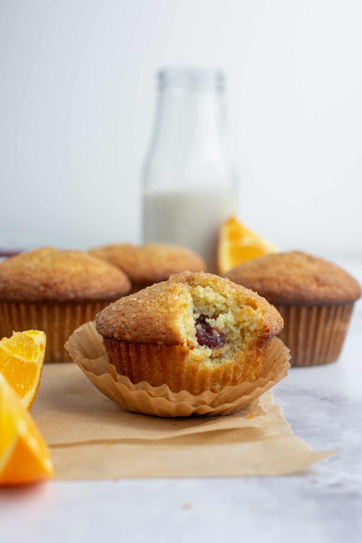 Cranberry Orange Muffins with a bite missing.
