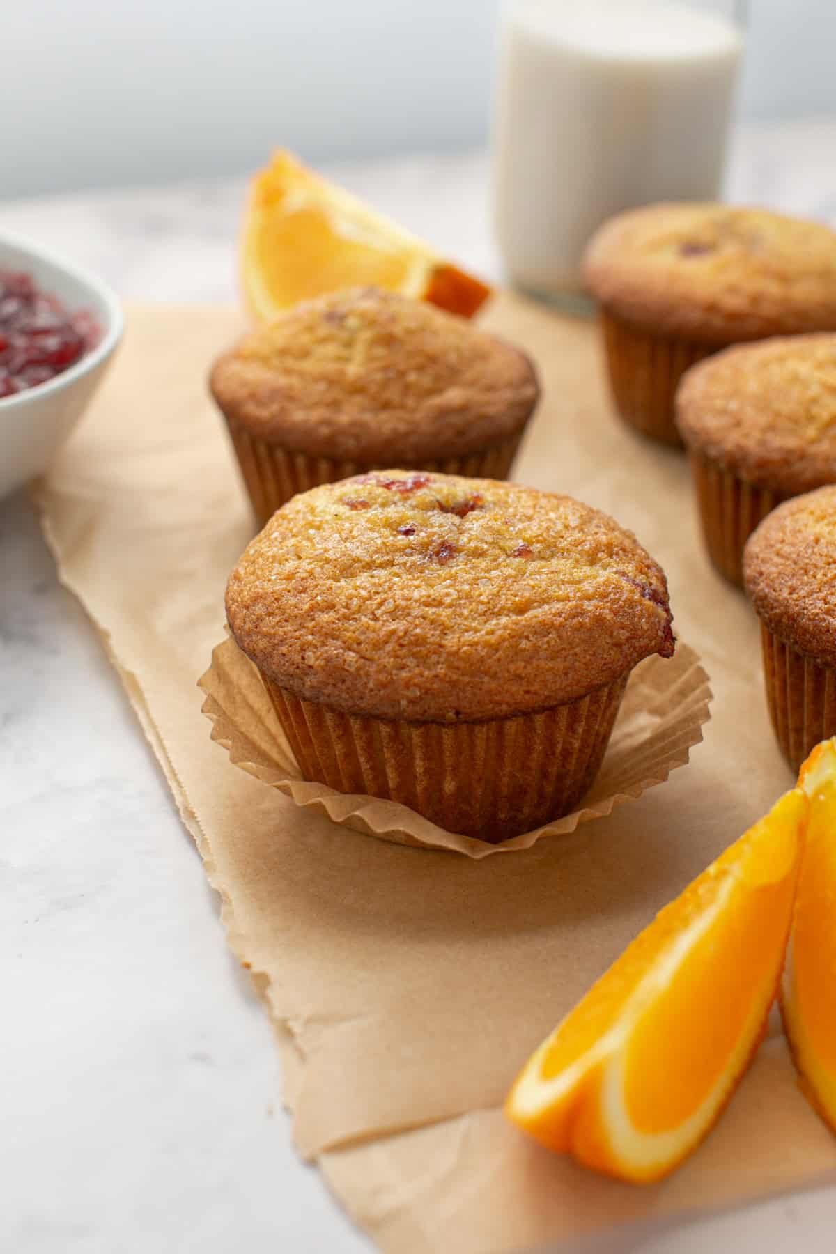 Bakery Style orange cranberry muffins on parchment paper.