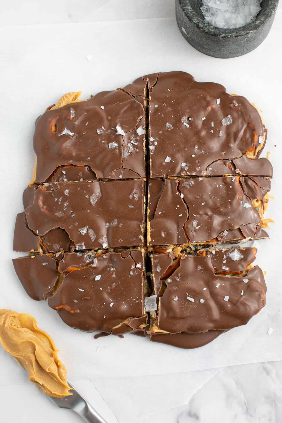 Chocolate Peanut Butter Pretzel Date Bark on parchment paper.